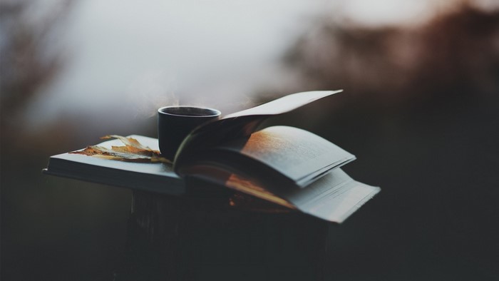 Open book with coffee and fall leaves