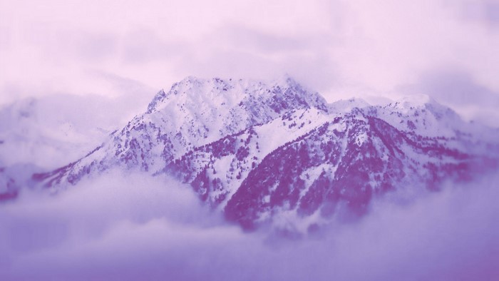 Snow-covered mountains shrouded in mist