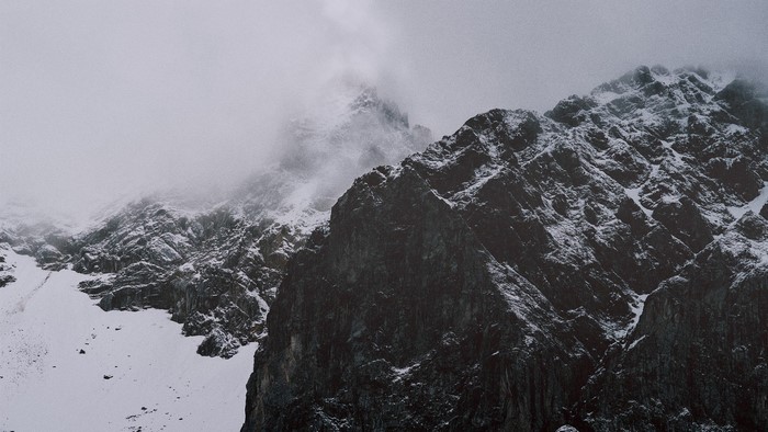 Snow-covered mountains shrouded in mist