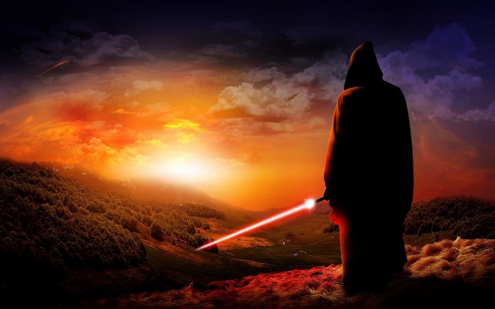 Figure with lightsaber at sunset