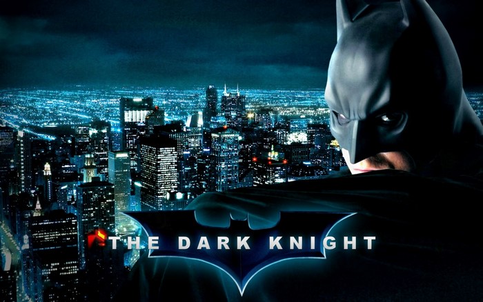 Batman from The Dark Knight over a city at night