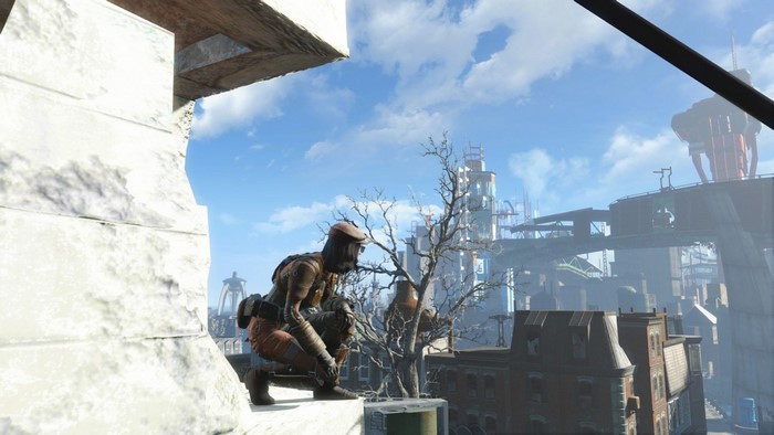 Fallout 4 character crouching on a rooftop overlooking city