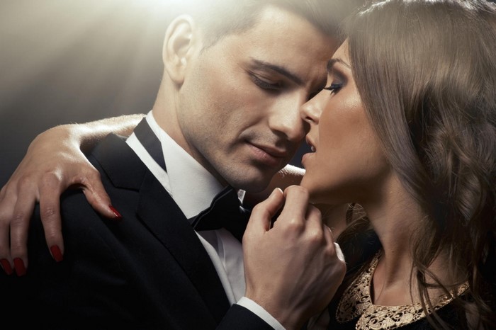 Couple in formal wear embracing intimately