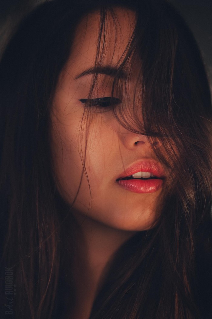 Close-up portrait of a woman with hair covering her face
