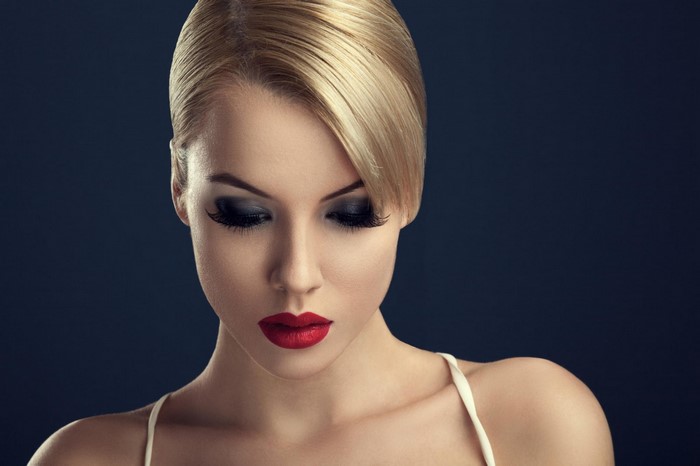 Blonde woman with dramatic makeup and red lipstick