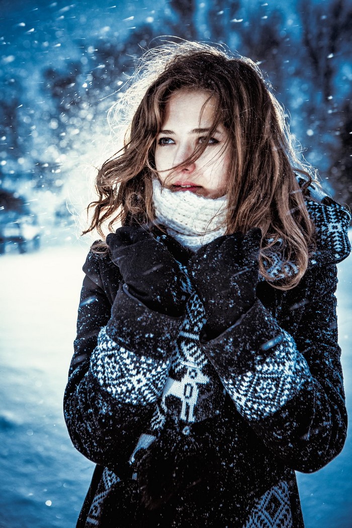 Woman in winter coat and scarf in snow