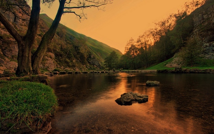 River flowing through a valley at sunset