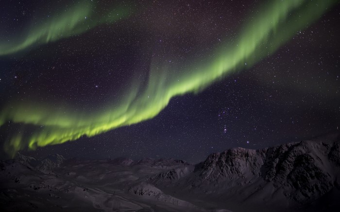 Aurora Borealis over snow-covered mountains