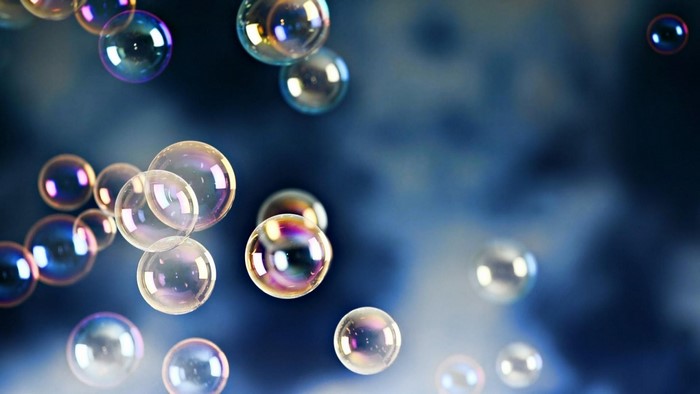 Bubbles floating in a dark blue, cloudy atmosphere