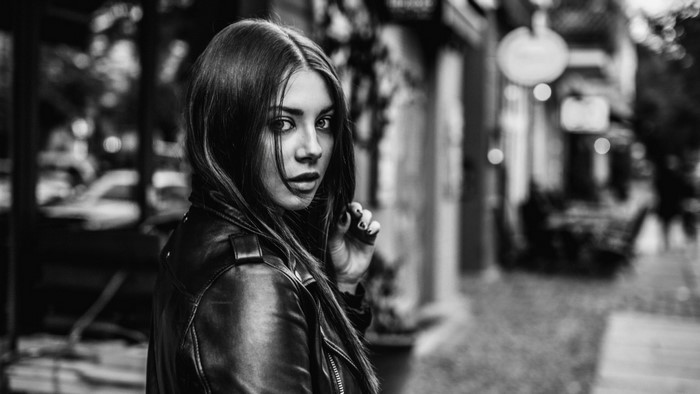 Woman in leather jacket looking over shoulder