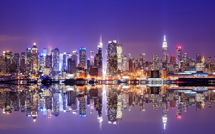 New York City skyline at night with reflections