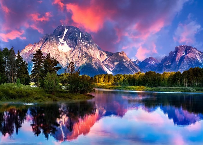 Mountain range reflected in a lake at sunset