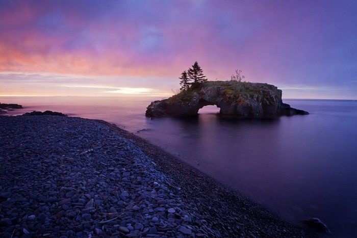 Arch rock formation in Lake Superior at sunrise