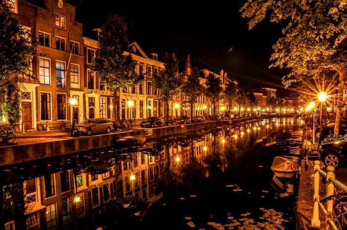 Cityscape at night with canal reflections and streetlights