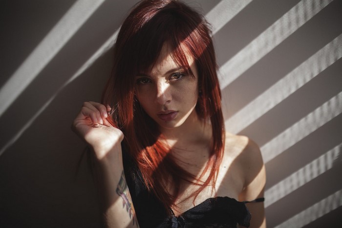 Woman with red hair and tattoo