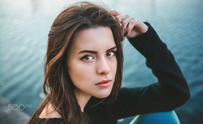 Portrait of a young woman with long brown hair