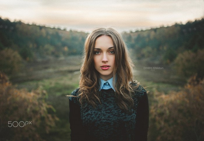 Woman with long brown hair in a forest