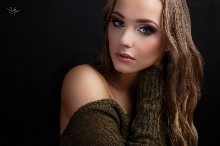 Woman with makeup and green sweater