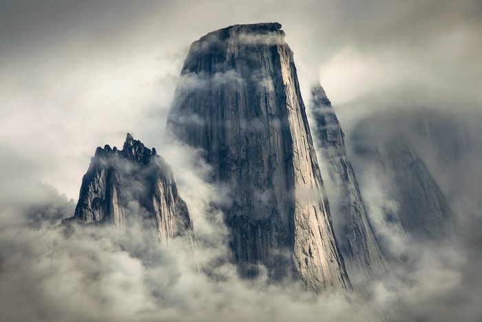Misty mountains with sunlight on cliffs