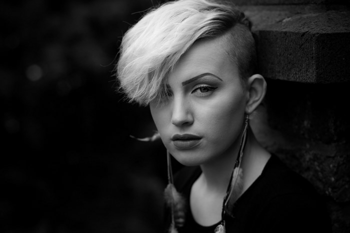 Monochrome portrait of a woman with shaved sides and blonde hair