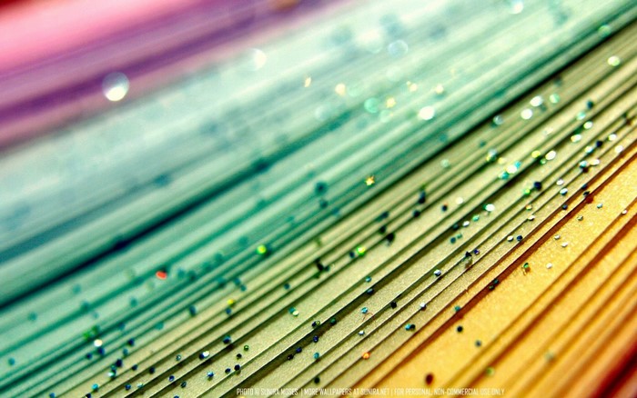 Close-up of colorful paper layers with glitter