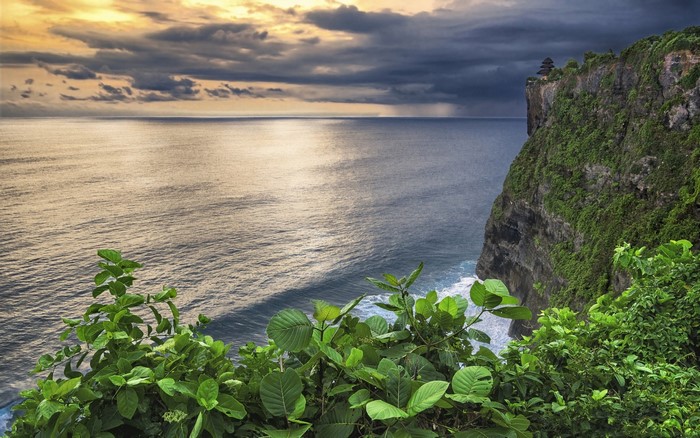 Cliff overlooking the ocean with a temple on top