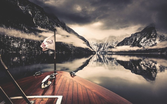 Boat on a lake with snowy mountains