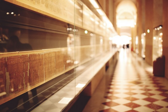 Ancient papyrus scrolls in a museum hallway