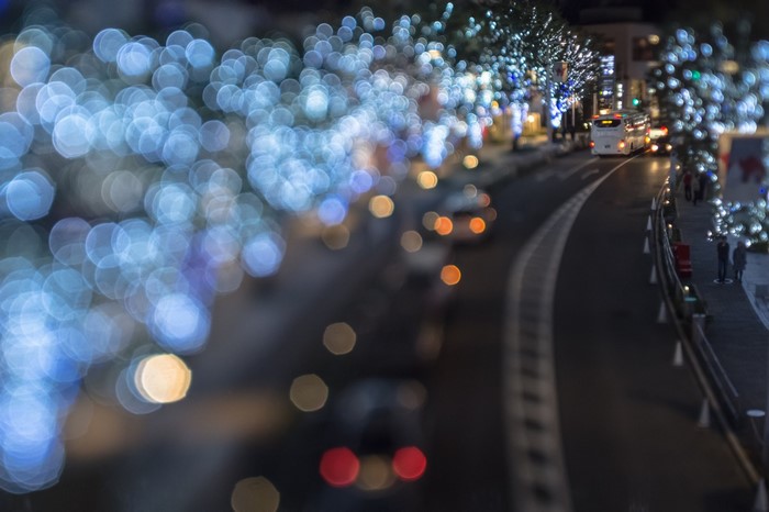 Night street with bokeh lights and a bus