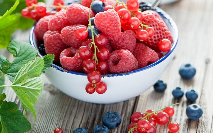 Bowl of fresh raspberries, blueberries, and red currants