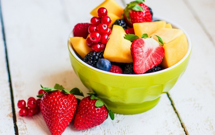 Bowl of fresh fruit salad with strawberries and berries