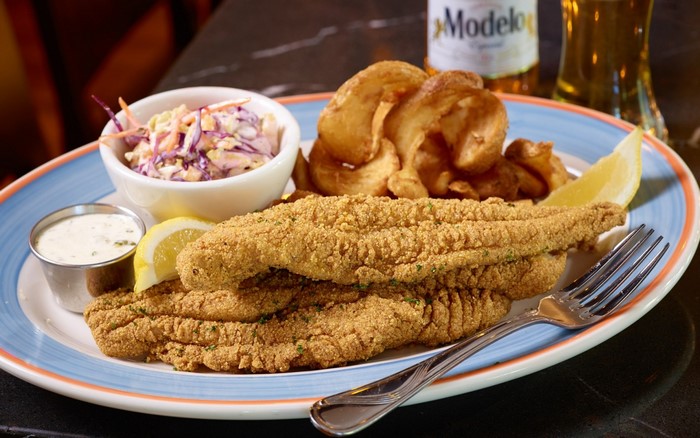 Fried fish with potato wedges and coleslaw
