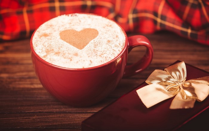 Red mug of coffee with heart shape and gift box