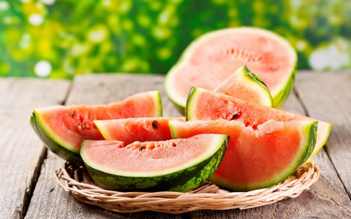 Slices of watermelon on a wooden surface