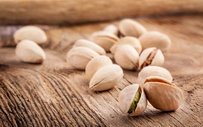 Pistachios on a wooden surface
