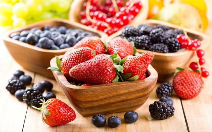 Fresh Mixed Berries in Wooden Bowls on Table