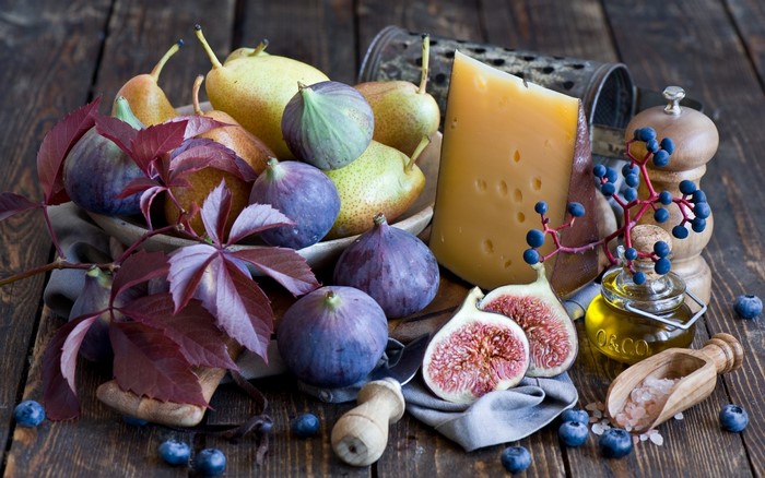 Still life of figs, pears, cheese, and blueberries