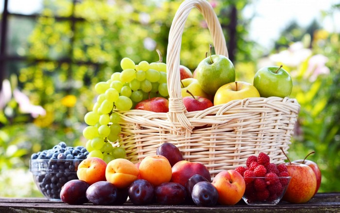 Basket of fresh fruits and berries outdoors