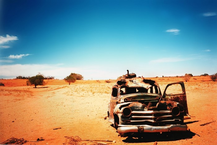Abandoned car in a desert landscape