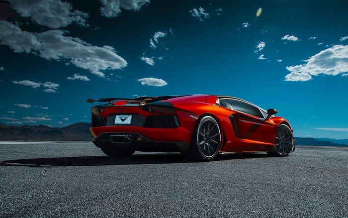 Red Lamborghini Aventador on asphalt road