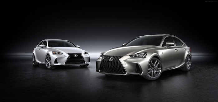 Two silver Lexus IS sedans on a dark background