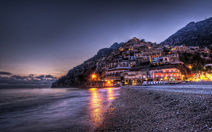 Positano cityscape at dusk with the sea and beach