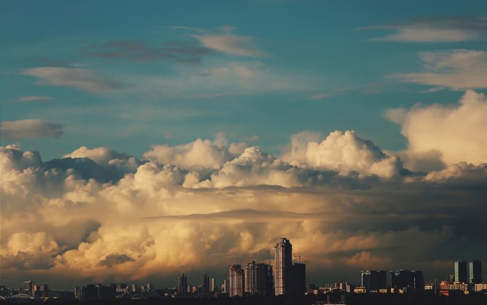 City skyline at sunset with dramatic clouds
