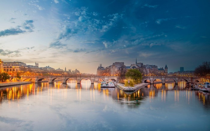 Paris cityscape with Seine River and bridges at dusk