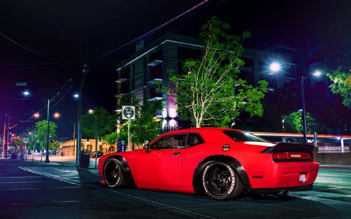 Red Dodge Challenger Widebody parked at night