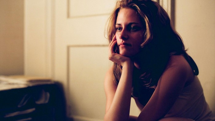 Kristen Stewart sitting with hand on chin