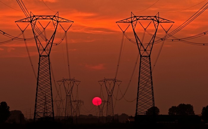 Sunset Behind Transmission Towers with Power Lines
