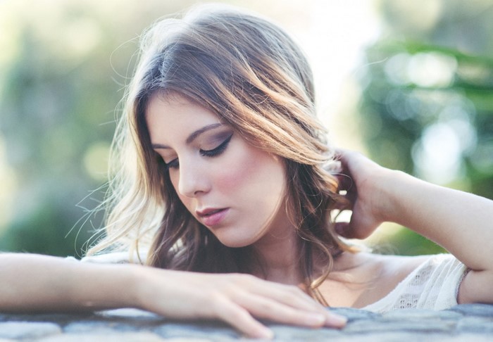Woman with long brown hair looking down