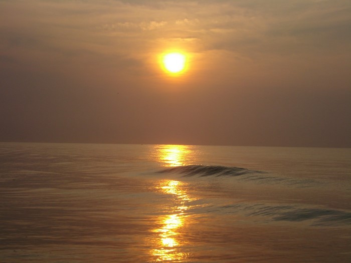 Sunset over the ocean with reflection