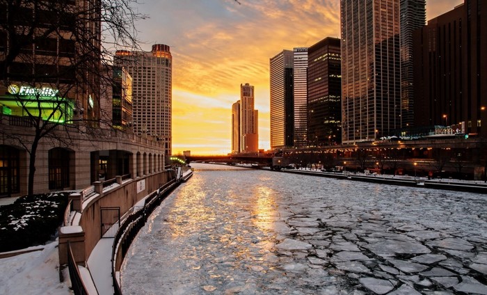 Chicago River at sunset with ice floes and skyscrapers